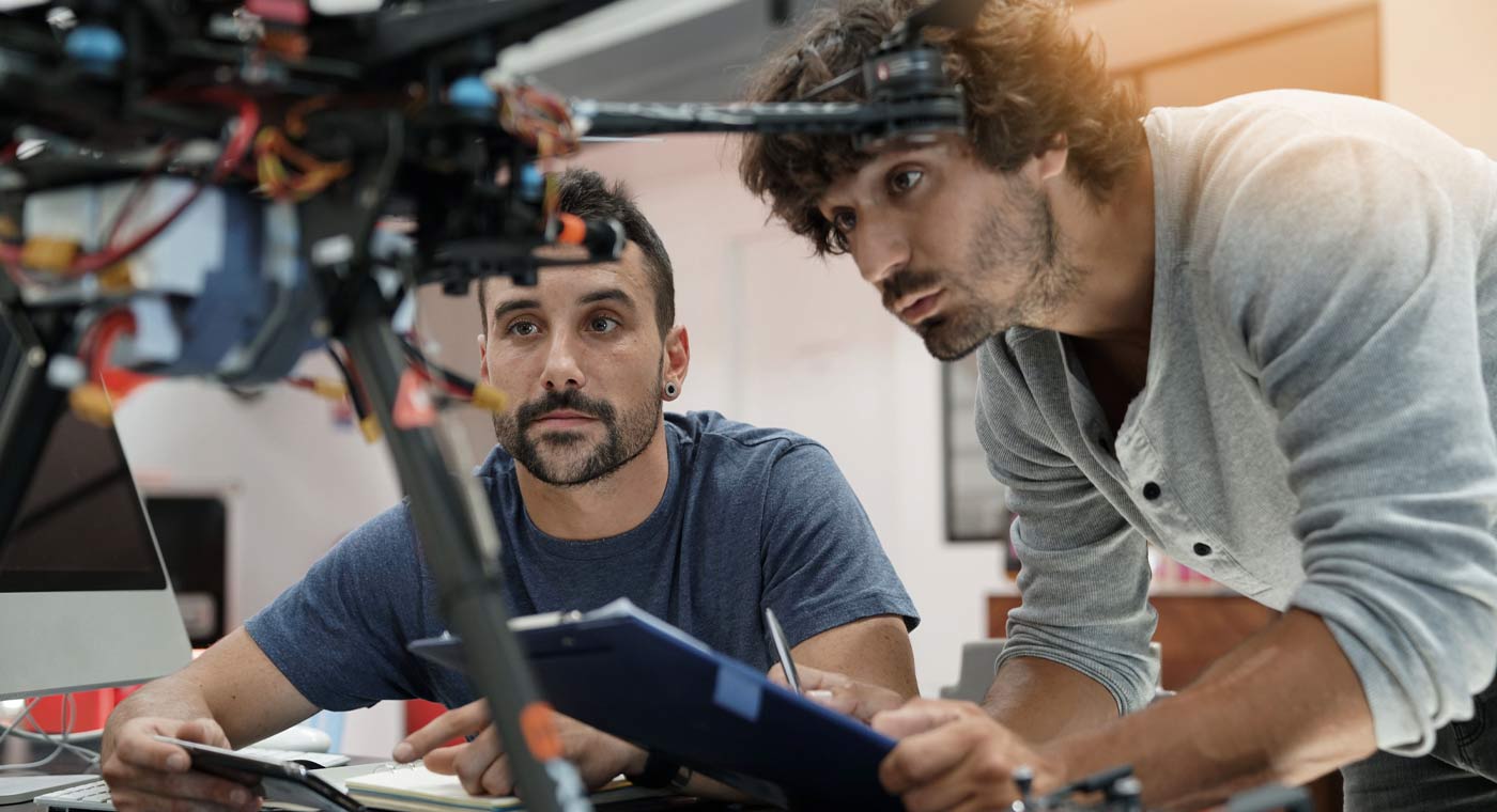Engineers working on drone technology in modern office setting