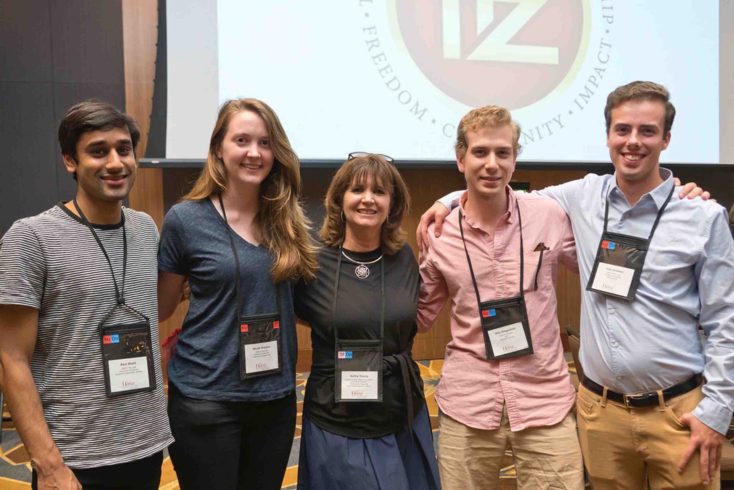 Group of five people smiling at a professional event