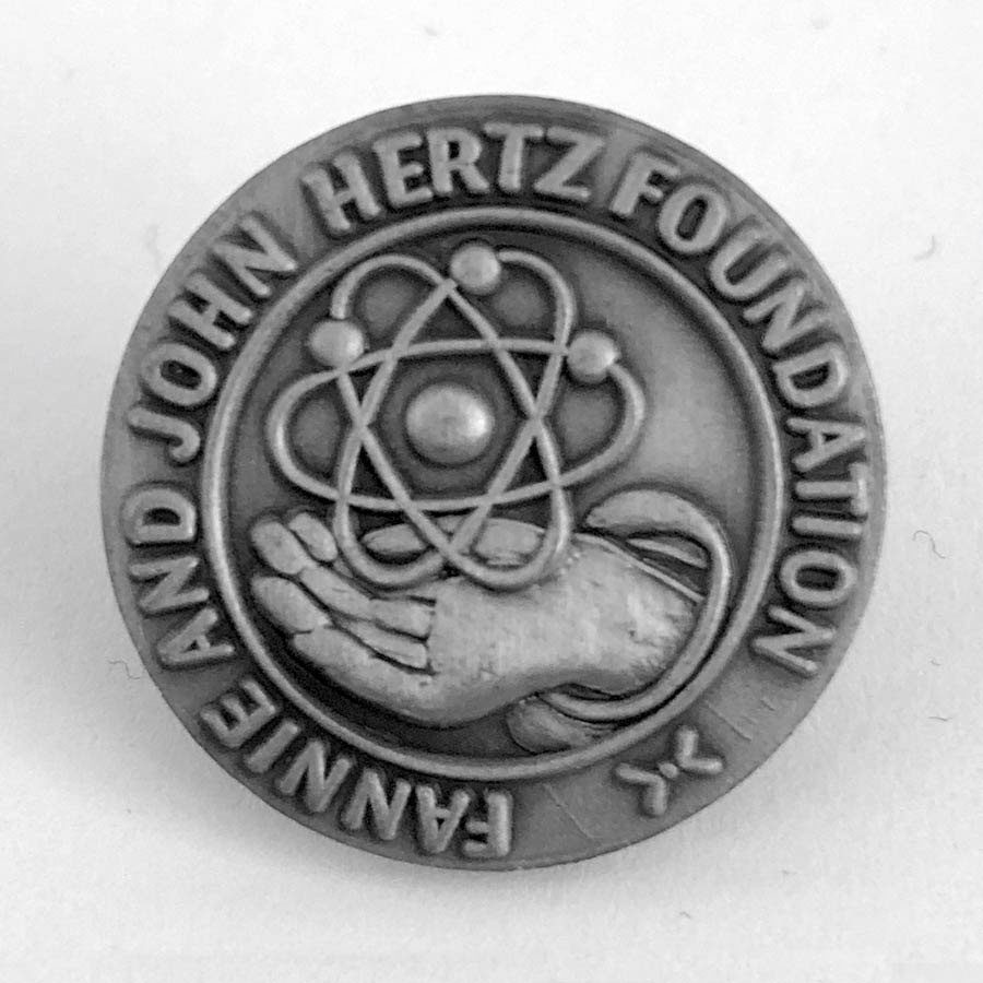 Fannie and John expressed their lifelong appreciation of the United States and the opportunities it presented them by establishing the Hertz Foundation in 1957.  Newspapers across the country announced that the bulk of their multimillion-dollar fortune would fund scholarships for engineers. The scholarships would subsidize more than 100 undergraduates each year, with the goal of increasing the country’s technological advancement.  After the death of John in 1961 and Fannie in 1963, the board of directors made a major modification in the foundation’s program. The undergraduate scholarship program was phased out, and financial support shifted to postgraduate fellowships for PhD students. The scope of studies expanded to include the applied sciences, with an emphasis on innovation.  The first Hertz Fellowships were awarded in 1963. Designed by Paul Fjelde in 1966, the original Hertz Foundation logo, pictured here, was used in awards and lapel pins.